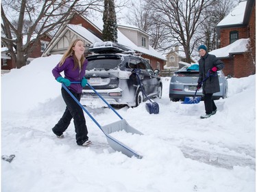 Joan Haysom and her daughter Alexandra Phaneuf, 15, shovel snow in front of their home in Wellington West as the city crawls out from under a major winter storm which is possibly the biggest of the season