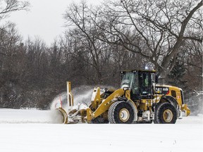 A loader plows the snow along the Sir John A. Macdonald Parkway on Jan. 20, 2019.