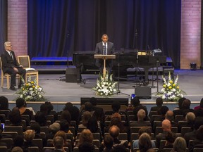 Emmanuel Kwame Ampionsah speaks at the Celebration of Life held for Pius Adesanmi at the Metropolitan Bible Church on Saturday, as pastor Rev. Randy jost looks on. Adesanmi was one of 18 Canadians killed in the Ethiopian Airlines crash last Sunday.
