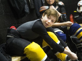 West Carleton Warrior Wally Lucente laces up for a practice on Sunday. The team, which won the $100,000 Chevrolet Good Deeds Cup for the work they did to help relief efforts following tornadoes that ripped through the Ottawa area last September, was honoured this weekend by Mayor Jim Watson and councillor Eli El-Chantiry.