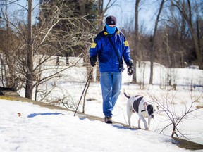 Lorne Murdock and his dog Boo were out for a stroll in the sunshine and chill winds in Britannia Park, Saturday March 23, 2019.   Ashley Fraser/Postmedia