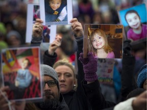 The Next Step Autism March, organized by two autism parents in Barrhaven, made its way to Parliament Hill Sunday March 30, 2019. Autism supporters took a moment of silence, holding up photos of those effected.   Ashley Fraser/Postmedia