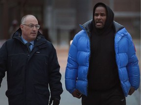 Singer R. Kelly, right, and his lawyer Steve Greenberg leave Cook County jail in Chicago after Kelly posted $100,000 U.S. bond on Feb. 25. Kelly had surrendered to face 10 charges of aggravated sexual abuse.