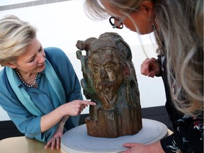 Cornelia Homburg (L), guest curator of the exhibition Gauguin Portraits, opening at gallery May 24 and Doris Couture-Rigert, Chief of Conseration of the National Gallery discuss Gaugin's wood sculpture.