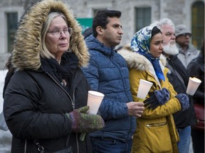 Judith Meyrick (L) was among those attending a vigil at the Human Rights Memorial in Ottawa in support of victims of the massacre in Christchurch, New Zealand on March 15, 2019.