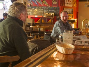 David Raynor, left, and Don, enjoy a beer at the Glue Pot Pub's coppertop bar. After 31 years in business, the Glue Pot is set to close at the end of March.