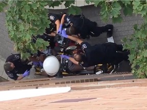 Still from witness video shows shows paramedics on scene outside Hilda Street apartment building where police confronted Abdirahman Abdi.