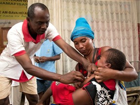 In this photograph taken on February 27, 2019, a Malagasy child is inoculated with Measles Vaccine during a measles epidemic, at a Basic Health Centre Level 2 (CSB 2) in the village of Anivorano, North Antsiranana on the outskirts of Antsiranana. - At least 926 children and young adults have died of measles in Madagascar since October, despite a huge emergency vaccination program, according to the World Health Organisation (WHO). Measles is a highly contagious viral disease that can cause complications including blindness and brain swelling and increase susceptibility to other diseases.