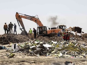 A power shovel digs at the crash site of Ethiopia Airlines near Bishoftu, a town some 60 kilometres southeast of Addis Ababa, Ethiopia, on March 11, 2019.