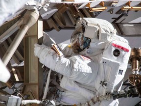(FILES) In this file photo taken on March 22, 2019 This image made available by NASA shows astronaut Anne McClain working on March 22, 2019, on the International Space Station's Port-4 truss structure during a six-hour, 39-minute spacewalk to upgrade the orbital complex's power storage capacity. - The US space agency NASA scrapped on March 25, 2019, a planned historic spacewalk by two women astronauts, citing a lack of available spacesuits that would fit them at the International Space Station.