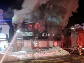 Firefighters battle a blaze at Allium restaurant on Holland Avenue on March 1, 2019.