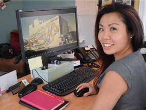 In this file photo, then-Quartier Vanier executive director Jamie Kwong shows on a computer the largest mural in the city, at 261 Montreal Rd.