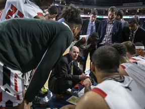 Ravens head coach Dave Smart speaks to his team during a timeout of a USports quarterfinal against Alberta on March 8.