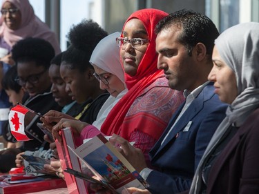 New Canadians listen to speeches as the Institute for Canadian Citizenship, together with Immigration, Refugees and Citizenship Canada, and the National Gallery of Canada, held a special community citizenship ceremony in the Great Hall at the National Gallery of Canada.
