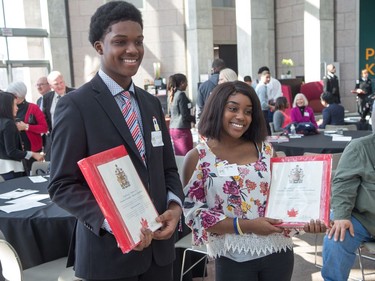 Irvin Stevenson Joseph and Myrlone Joseph show off their citizenship documents as the Institute for Canadian Citizenship, together with Immigration, Refugees and Citizenship Canada, and the National Gallery of Canada, held a special community citizenship ceremony in the Great Hall at the National Gallery of Canada.