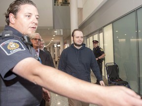 Joshua Boyle is escorted by authorities to a media availability at Toronto's Pearson International Airport on Friday, October 13, 2017. Former Afghanistan hostage Joshua Boyle is slated to be in Ontario court today to face trial on several assault charges.