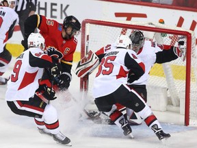 The Calgary Flames' Mark Giordano jams a first-period goal past Senators goalie Craig Anderson on Thursday, March 21, 2019.