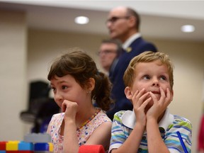 In this file photo, Social Development Minister Jean-Yves Duclos is shown in the background while a few younger Canadians focus on play. How should we interpret government announcements on child poverty reduction goals?