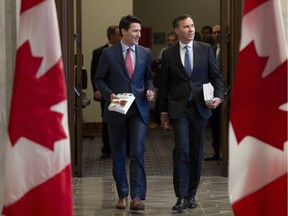 Prime Minister Justin Trudeau and Finance Minister Bill Morneau speak as they walk to the House of Commons in Ottawa, Tuesday March 19, 2019.