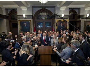 Conservative leader Andrew Scheer speaks to media, with his caucus behind him, after walking out of the House of Commons during Finance Minister Bill Morneau's budget speech to protest the handling of the SNC-Lavalin affair.