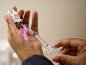 In this Feb. 7, 2018 file photo, a nurse prepares a flu shot at the Salvation Army in Atlanta.