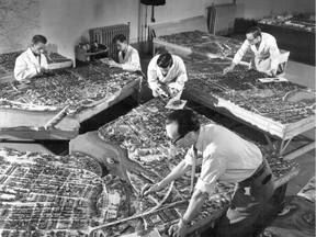 City employees work on a model of central  Ottawa (about 1950) for the Federal District Commission – later to become the National Capital Commission.  The model shows the city under proposals made by Jacques Gréber.