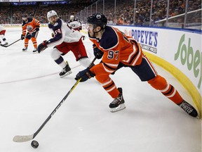 Columbus Blue Jackets' Adam McQuaid (54) chases Edmonton Oilers' Connor McDavid (97) during second period NHL action in Edmonton, Alta., on Thursday March 21, 2019.