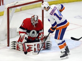Ottawa Senators goaltender Anders Nilsson makes a save as New York Islanders right-winger Tom Kuhnhackl looks for a rebound during the second period at the CTC on Thursday, March 7, 2019.