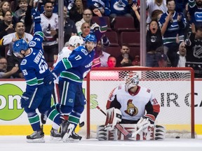 The Vancouver Canucks' Bo Horvat (53) celebrates his goal against Ottawa Senators goalie Anders Nilsson as Vancouver's Josh Leivo (17) watches during the first period on Wednesday, March 20, 2019.