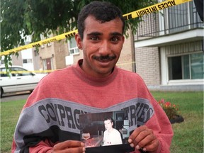 Khaled Farhan holds a picture of his then-missing girlfriend Karina Janveau shortly before he was arrested and charged with killing her.