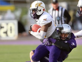 Western linebacker Fraser Sopik wraps up Laurier wide receiver Kurleigh Gittens Jr. during the Yates Cup held in London, Ont. on Saturday November 11, 2017.