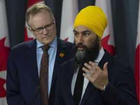 NDP MP Peter Julian looks on as leader Jagmeet Singh speaks during a news conference in Ottawa, Wednesday March 13, 2019. A pillar of the federal New Democrats' fiscal plan for the fall election will be shaped by soon-to-be-released estimates on how much revenue Ottawa loses out on each year to international tax-avoidance schemes, the party's finance critic says.