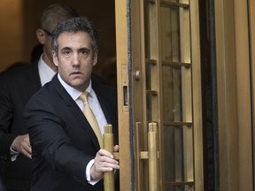 FILE - In this Aug. 21, 2018, file photo, Michael Cohen leaves Federal court, in New York. Newly released documents show the FBI was investigating President Donald Trump's former personal attorney and fixer for nearly a year before agents raided his home and office. A search warrant released Tuesday, March 19, 2019 shows the federal inquiry into Cohen had been going on since July 2017, far longer than had previously been known.