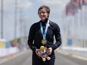 FILE - In this Wednesday, July 22, 2015 file photo, United States gold medalist Kelly Catlin poses after winning the women's individual time trial cycling competition at the Pan Am Games in Milton, Ontario. Olympic track cyclist Kelly Catlin, who helped the U.S. women's pursuit team win the silver medal at the Rio de Janeiro Games in 2016, died Friday, March 8, 2019 at her home in California. She was 23.
