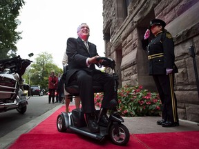 Outgoing Ontario Lieutenant-Governor David Onley is saluted while arriving for his last full day in office at Queen's Park in Toronto on Monday, September 22, 2014. A former Ontario lieutenant-governor tasked with reviewing the disability legislation says the province is nowhere near meeting its stated goal of full accessibility by 2025.