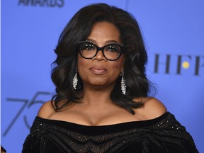 In this Jan. 7, 2018 file photo, Oprah Winfrey poses in the press room with the Cecil B. DeMille Award at the 75th annual Golden Globe Awards in Beverly Hills, Calif. Winfrey will interview two men who say Michael Jackson sexually abused them as boys immediately after a documentary on the men.