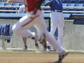 Blue Jays right fielder Demi Orimoloye (right) tries to hang on to a pop foul by Canada Jr. team’s Dasan Brown during Spring Training in Dunedin, Fla., yesterday. (AP)