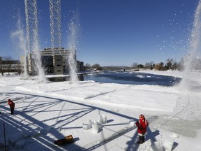 Ottawa city crews blast ice south of the Minto bridges on the Rideau River on Monday in advance of the annual spring thaw to prevent flooding.