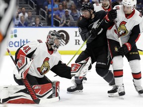 Ottawa Senators goaltender Craig Anderson makes a save in front of Tampa Bay Lightning center Tyler Johnson Saturday inTampa, Fla.