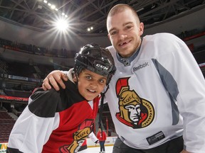 Ottawa Senators defenceman Mark Borowiecki with a participant at the annual Skate for Kids, one of the many charity events supported by the Ottawa Senators Foundation.