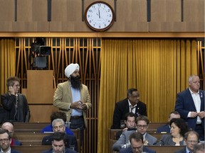 The clock reads one minute to midnight as Liberal MPs Brenda Shanahan, left, Randeep Sarai, Ramesh Sangha and Darrell Samson rise to vote during a marathon voting session as it continues into the night in the House of Commons on Parliament Hill in Ottawa on Wednesday, March 20, 2019.