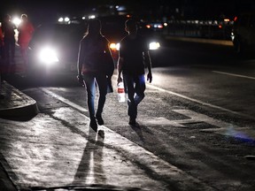 A couple walks along a street during a power outage in Caracas on March 7, 2019.