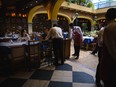 Customers dine at a restaurant powered by an electric generator in Caracas, Venezuela, on Tuesday, March 12, 2019. Caracas began going dry Monday as the countrys power crisis put utilities out of commission, risking supplies for 5.5 million people.