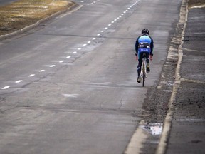 A cyclist travels along Carling Ave.