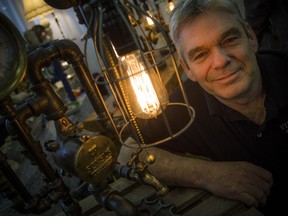 Val-des-Monts firefighter Brian Killeen of Vint-Age Steampunk Industrial Lamps beside one of his creations at the Ottawa Antique & Vintage Market.