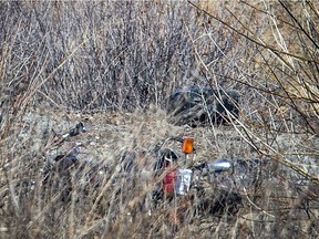 A motorcycle is visible in the ditch at the scene of a fatal single-vehicle accident Saturday on the Hunt Club off-ramp from Highway 416.