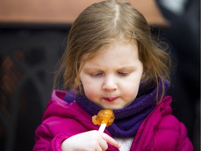 Three-year-old Anna Natynczyk enjoyed the taffy at the 35th edition of Vanier's Sugar Festival that took place Saturday April 6, 2019.    Ashley Fraser/Postmedia