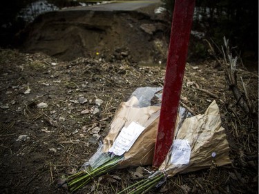 The scene of the washed out road where Louise Séguin Lortie, 72, died after her car plunged into a washed out section of Chemin Bronson Bryant in Pontiac. Her daughters had placed flowers at the edge of the washed out road.