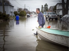 The low lying areas around Ottawa and Gatineau were hit with the beginning of the flooding near the rivers, Sunday, April 21, 2019. Randy Provost saves his boat before it almost drifted down the Ottawa River after the rope somehow snapped. Provost who has lived on Rue Riviera for 28 years says he has only experienced flooding like this twice, 2017 being the last time.   Ashley Fraser/Postmedia