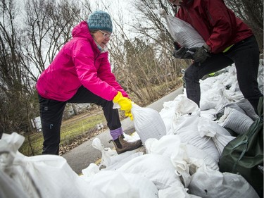 Volunteers, including Deb Hine, came out to sandbag along the Ottawa River Pathway where the Ottawa River was creeping close to breaking over which would cause major flooding in the Britannia area, Saturday, April 27,